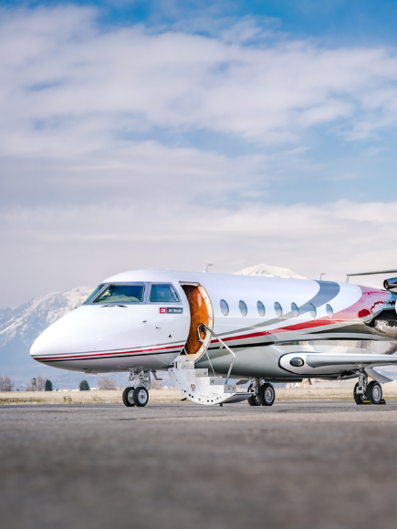 plane siting on runway with stairs dropped down